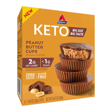 Atkins Keto peanut butter cups box, angled view with dark chocolate cup and peanut pieces