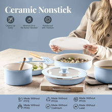 Blue ceramic nonstick pots and pans on a table with lids and matching handle