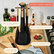 Rotating rack holding black silicone kitchen utensils with gold handle accents