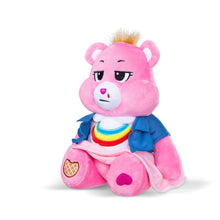Pink plush bear with closed eyes expression, blue jacket, rainbow collar