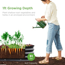 Charcoal oval raised garden bed planter with deep soil and vegetables
