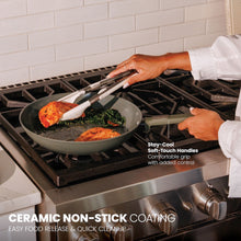 Moss green ceramic non-stick fry pan on stove with two stay-cool grips, cooked food