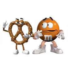 Two M&M's characters, one pretzel-shaped, standing with white sneakers and gloves