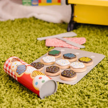 Wooden cookie play set roller and decorated cookie discs on a gray tray