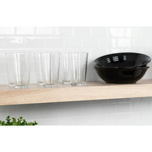 Black round bowl with ridged design, paired with stacked clear tumblers