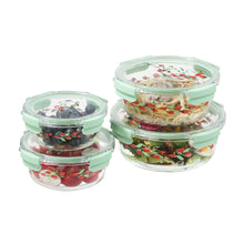 Stacked set of round glass food storage containers with green lids and floral print