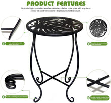 Black metal plant stand with round perforated top and curved X-shaped base frame.
