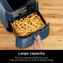 Navy air fryer basket open with French fries, black handle and insert