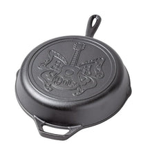 Seasoned cast iron skillet lid side with butterfly engraving and loop handle