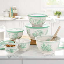 Green floral mixing bowl set with one utensil and assorted bowls
