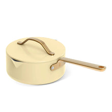 Buttercream covered saucepan with strainer lid and gold side handle