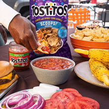 Tostitos Scoops! tortilla chips bag with chips and salsa dips on table