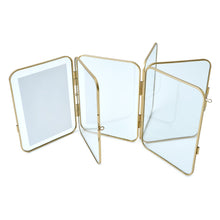 Three-panel gold metal folding picture frame shown folded with multiple clear panels