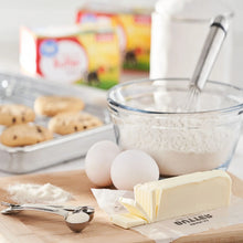 Salted sweet cream butter sticks with sliced pieces and wrapper on a tray