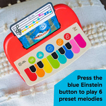 Close-up of red baby piano toy panel with colorful keys and music screen