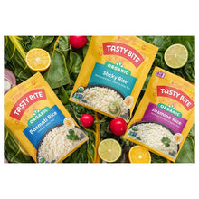 Organic basmati rice pouches on leafy greens with lime and radish