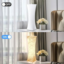 Pair of tall fabric table lamps with textured white shades, one lit and one off