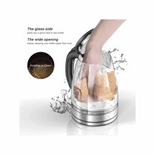 Electric glass kettle with wide opening and clear body during pouring