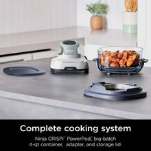 Ninja Crispi air fryer with clear glass container on countertop, with storage lid