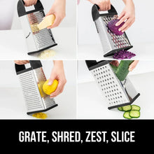Stainless steel box grater with black handle grating cheese, purple cabbage, and cucumber