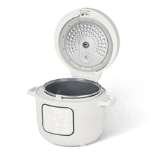 White electric rice cooker with lid open, showing vented inner lid and dark inner pot
