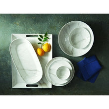 White marble-look melamine serving bowl, round shallow shape on tabletop