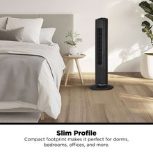 Black tower fan standing on the floor with slim vertical air vents