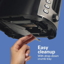 Toaster with drop-down crumb tray pulled out for easy cleanup