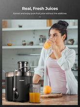Black juicer machine with wide chute and juice cup beside pulp collector