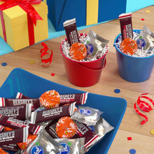 Assorted zero sugar candy variety with wrapped pieces in red and blue gift cups