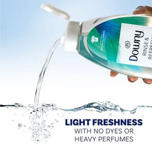 Downy rinse-and-refresh fabric softener bottle pouring water, light blue stream
