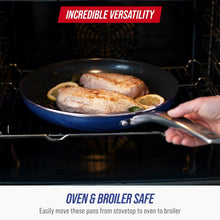 Ceramic nonstick frying pan in an oven with dark blue interior and metal handle