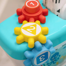 Blue and yellow 2-in-1 potty training toy with gear-style buttons and round control