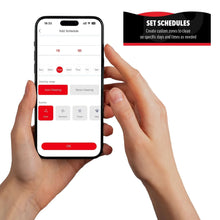 Smartphone displaying robot vacuum schedules in app, held by a hand
