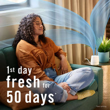 White Febreze Plug oil warmer releasing vapor for fresh room scent