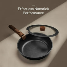 Black nonstick frying pan with glass lid and wooden handle