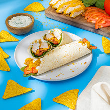 Tortilla chips with dipping sauces and taco wraps on a plate