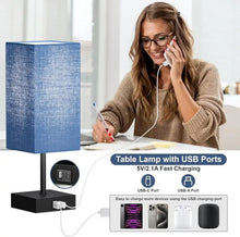 Blue fabric table lamp with black base and USB charging ports