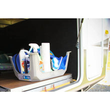 Gray plastic step stool visible beside cleaning items inside an open vehicle compartment