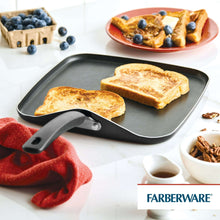 Black nonstick griddle pan with three slices of toast and long handle