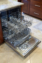 Dishwasher rack filled with clear glass mugs