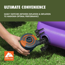 Electric air pump on grass inflating a purple inflatable with black nozzle adapters