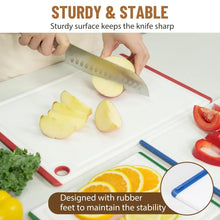 Plastic cutting board with multicolor border, food prep with a chef’s knife