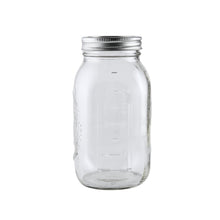 Empty clear glass Mason jar with metal airtight lid and measurement markings