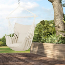 Beige hammock chair swing with hanging rope seat and two cushion pads