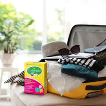 Culturelle Kids probiotic chewable tablets box beside folded clothes in suitcase