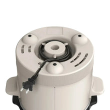 Slow cooker base with exposed heating element and lid handle on white interior