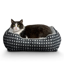 Plush pet bed with black outer fabric featuring white diamond pattern and gray inner pad