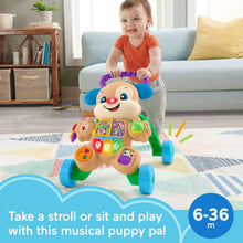 Musical puppy walker toy with smiling face, held by a toddler; colorful activity panel