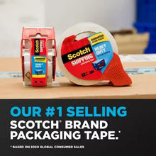 Red tape dispenser and large clear tape roll on a tabletop